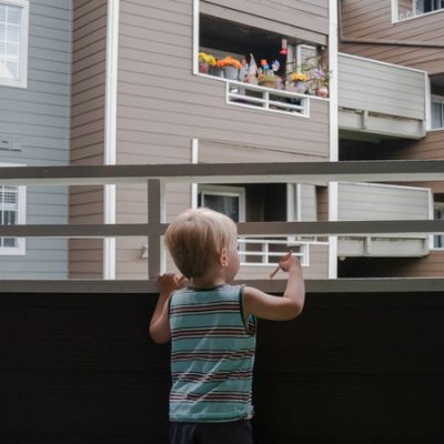 Grigory Vodolazovs 3 year old son peers into his familys apartment complex from their unit in Bellevue Wash The Vodolazov family is part of Creating Moves to Opportunity a housing voucher experiment that uses incentives and counseling to encourage low income families to move to what are called high opportunity areas